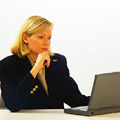 Image of a training manager working on her computer - learner tracking